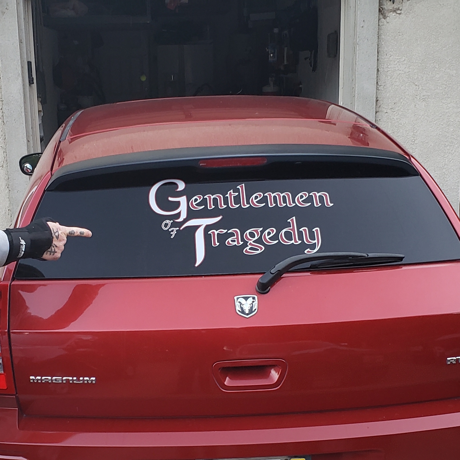 Custom white lettering on a red vehicle rear window